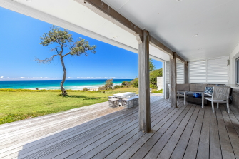Front porch overlook the beach on a bright sunny day | Featured Image for the Saltwater Beach House on Prestige Holiday Homes.