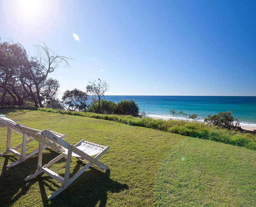 Deck chairs overlooking the beach at Malibu Beachfront at Coolum Beach Holiday Home.