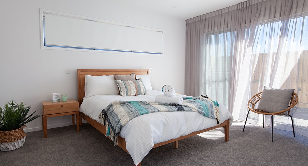 Queen bed with natural lighting at Sea Renity Coolum Beach | Sunshine Coast Holiday Homes