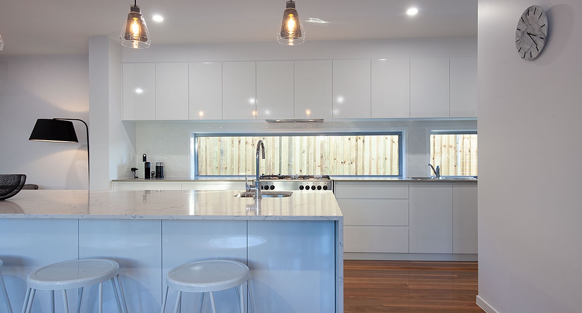 View of kitchen and a clock at Sea Renity Coolum Beach | Sunshine Coast Holiday Homes