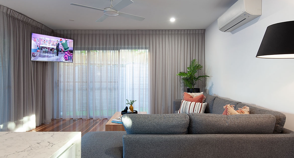 Living room with wall mounted TV at Sea Renity Coolum Beach | Sunshine Coast Holiday Homes