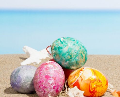 Colourful Easter eggs on the sand | Prestige Holiday Homes