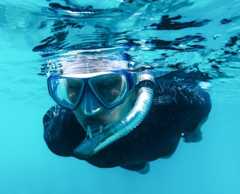 Guy Snorkeling using wet suit | Featured image for Best Places to Go Snorkelling Sunshine Coast | Blog
