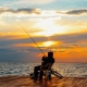 Guy fishing at the beach during a beautiful sunset | Featured image for Best Places to go Fishing Sunshine Coast | Blog