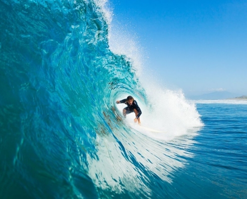 Guy Surfing | Featured image for Best Places to Surf Sunshine Coast | Blog